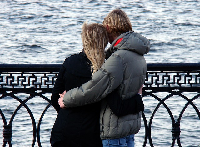 Couple on a bridge overlooking the water, on a date in Chicago