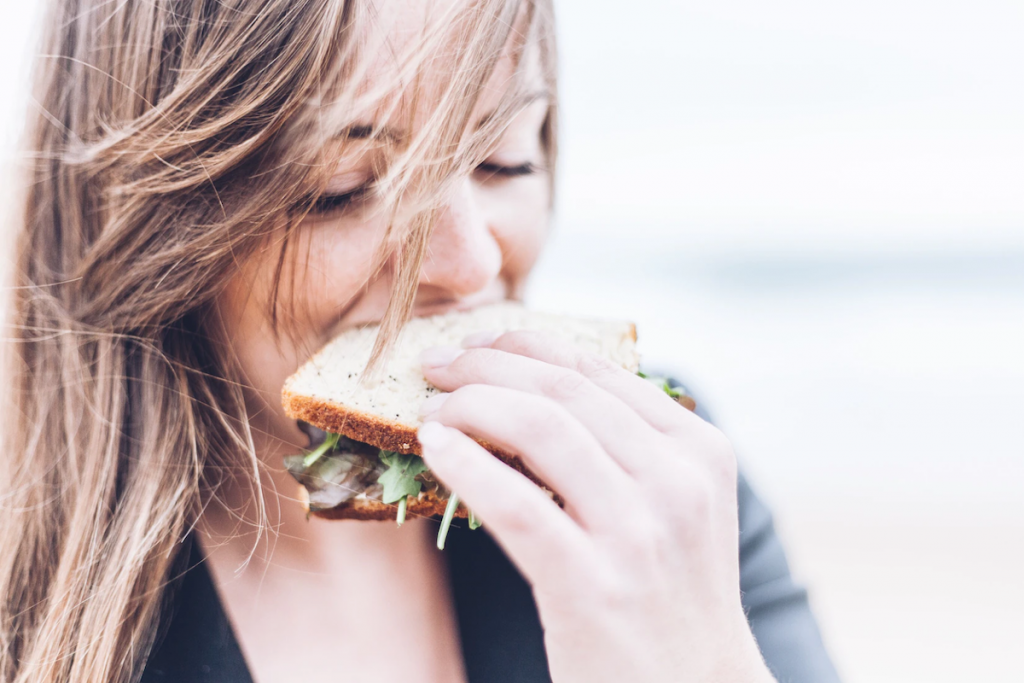 Women eating a healthy sandwich. 